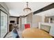 Open concept living room and kitchen with exposed brick, modern lighting, wood floors, and stainless appliances at 10809 Garden Mist Dr Dr # 2041, Las Vegas, NV 89135