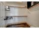 Spacious walk-in closet features wooden shelves and hanging rods at 10809 Garden Mist Dr Dr # 2041, Las Vegas, NV 89135
