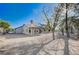 Expansive backyard with a covered patio, mature trees, and potential for landscaping at 1580 Albino Dr, Henderson, NV 89002