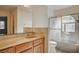 Well-lit bathroom with a marble-look vanity, tub-shower combo, and neutral color scheme at 1580 Albino Dr, Henderson, NV 89002