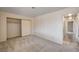 This bedroom features a neutral carpet, sliding door closet and access to the hallway at 1580 Albino Dr, Henderson, NV 89002