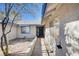 Single-story home featuring stucco siding, blue trim, a desert landscape, and a pathway to the front door at 1580 Albino Dr, Henderson, NV 89002