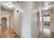 Hallway with wood-look floors, arched doorways and neutral walls, providing seamless transitions between rooms at 1580 Albino Dr, Henderson, NV 89002