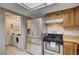 Well-equipped kitchen with stainless steel appliances and adjacent laundry area for added convenience at 1580 Albino Dr, Henderson, NV 89002