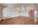 Spacious living area with hardwood floors, bright lighting, and an arched doorway, ready for personalization at 1580 Albino Dr, Henderson, NV 89002