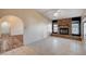 Open floorplan featuring tile floors and a stone fireplace, seamlessly connecting the living spaces at 1580 Albino Dr, Henderson, NV 89002