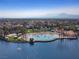 Scenic aerial view of community lagoon, with sandy beach and mountains in the background at 3024 Pismo Beach Dr, Las Vegas, NV 89128