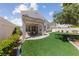 Backyard featuring artificial grass and a covered patio at 3024 Pismo Beach Dr, Las Vegas, NV 89128