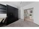 Spacious bedroom with black wardrobe, desk, carpet flooring, and ample natural light at 3024 Pismo Beach Dr, Las Vegas, NV 89128