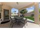 Relaxing covered patio with a dining table, offering a comfortable outdoor space for meals and gatherings at 3024 Pismo Beach Dr, Las Vegas, NV 89128