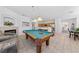 Open-concept game room with pool table, fireplace, kitchen with bar, and dining area at 3024 Pismo Beach Dr, Las Vegas, NV 89128
