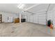 Spacious garage with ample shelving, a refrigerator, and room for two cars and garage door at 3024 Pismo Beach Dr, Las Vegas, NV 89128