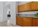Kitchen features granite counters, wooden cabinets, and tile floors at 3024 Pismo Beach Dr, Las Vegas, NV 89128
