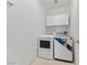 Efficient laundry room featuring a washer, dryer, and functional cabinet space at 3024 Pismo Beach Dr, Las Vegas, NV 89128