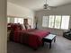 Bright main bedroom features a ceiling fan, bench, and plantation shutters allowing natural light at 3024 Pismo Beach Dr, Las Vegas, NV 89128