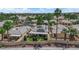 Aerial view of home featuring a covered patio, green lawn and mature landscaping at 328 Wild Plum Ln, Las Vegas, NV 89107