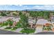 Aerial view showcases desert landscaping and mature trees surrounding the home at 328 Wild Plum Ln, Las Vegas, NV 89107
