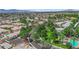 Picturesque aerial view of a community featuring mature trees, landscaping and a community pool at 328 Wild Plum Ln, Las Vegas, NV 89107