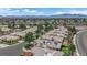 Serene aerial view of a neighborhood featuring mature trees, landscaping and solar panels at 328 Wild Plum Ln, Las Vegas, NV 89107