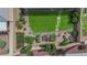Charming backyard featuring a garden area, well-maintained lawn and rock landscaping at 328 Wild Plum Ln, Las Vegas, NV 89107