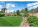 Beautiful backyard with a well-manicured lawn, mature landscaping, and a peaceful garden view at 328 Wild Plum Ln, Las Vegas, NV 89107