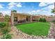 Expansive backyard featuring lush green grass, mature trees, manicured landscape, perfect for outdoor enjoyment at 328 Wild Plum Ln, Las Vegas, NV 89107