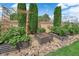 Backyard garden featuring plants in raised metal containers and rock landscaping at 328 Wild Plum Ln, Las Vegas, NV 89107