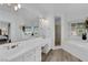 A luxurious primary bathroom features a double sink, separate shower, and soaking tub at 328 Wild Plum Ln, Las Vegas, NV 89107