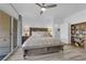 Comfortable bedroom with a ceiling fan, an exterior view, and a bookshelf at 328 Wild Plum Ln, Las Vegas, NV 89107
