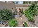 Small garden with raised beds, plants, and gravel perfect for gardening, surrounded by a block wall at 328 Wild Plum Ln, Las Vegas, NV 89107