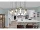 Spacious kitchen with white cabinets, stainless steel appliances and white countertops overlooking dining room at 328 Wild Plum Ln, Las Vegas, NV 89107