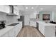 Open white kitchen with stainless steel appliances and white countertops overlooking the dining room at 328 Wild Plum Ln, Las Vegas, NV 89107
