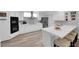 Updated kitchen with white cabinets, stainless steel appliances, white countertops and oversized island at 328 Wild Plum Ln, Las Vegas, NV 89107