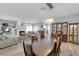 Open floor plan with fireplace, dining table, light blue paint, and wood look flooring at 328 Wild Plum Ln, Las Vegas, NV 89107
