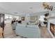 Bright, open living room with fireplace, wood floors, and view of the dining area at 328 Wild Plum Ln, Las Vegas, NV 89107