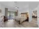 Bright and airy main bedroom with wood look flooring and access to the backyard at 328 Wild Plum Ln, Las Vegas, NV 89107