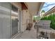 Covered patio area with BBQ, exterior door, and firewood storage, perfect for entertaining at 328 Wild Plum Ln, Las Vegas, NV 89107