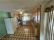 Functional kitchen features linoleum flooring, wooden cabinets, and a window overlooking the backyard at 4244 Gibraltar St, Las Vegas, NV 89121