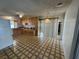 Functional kitchen featuring linoleum flooring, wooden cabinets, and sliding glass door to back yard at 4244 Gibraltar St, Las Vegas, NV 89121
