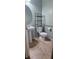 A small bathroom featuring a pedestal sink, toilet, tiled floors, and metal shelving at 4590 Lime Straight Dr, Las Vegas, NV 89115