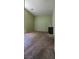 A carpeted bedroom featuring plain light green walls and a small side table at 4590 Lime Straight Dr, Las Vegas, NV 89115
