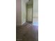 A carpeted hallway featuring a white door and light green walls leading into the home at 4590 Lime Straight Dr, Las Vegas, NV 89115