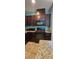 A kitchen featuring dark wood cabinetry, granite countertops, and a black gas range and oven at 4590 Lime Straight Dr, Las Vegas, NV 89115