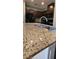 Close-up of a kitchen island with granite countertop and a stainless steel sink at 4590 Lime Straight Dr, Las Vegas, NV 89115