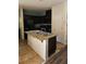 A kitchen featuring a central island with a sink and counter, complemented by dark cabinets and modern appliances at 4590 Lime Straight Dr, Las Vegas, NV 89115