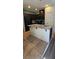 A kitchen island with granite countertop, stainless steel sink, and white base cabinets at 4590 Lime Straight Dr, Las Vegas, NV 89115