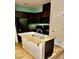 Well-lit kitchen with dark cabinetry, granite countertops, and a functional kitchen island at 4590 Lime Straight Dr, Las Vegas, NV 89115