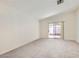 A bright bedroom with a sliding glass door, carpeted floors, and ample natural light at 5114 Mascaro Dr, Las Vegas, NV 89122