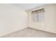 Cozy bedroom features neutral carpet, and natural light through window with blinds at 5114 Mascaro Dr, Las Vegas, NV 89122