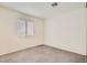 Carpeted bedroom features a window with blinds, neutral walls, and ample natural light at 5114 Mascaro Dr, Las Vegas, NV 89122